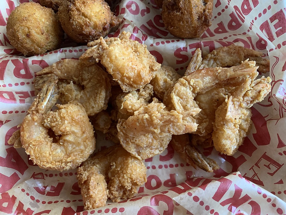 We got extra hushpuppies as both our side orders with the 12-piece fried shrimp dinner from Eat My Catfish in west Little Rock. (Arkansas Democrat-Gazette/Eric E. Harrison)