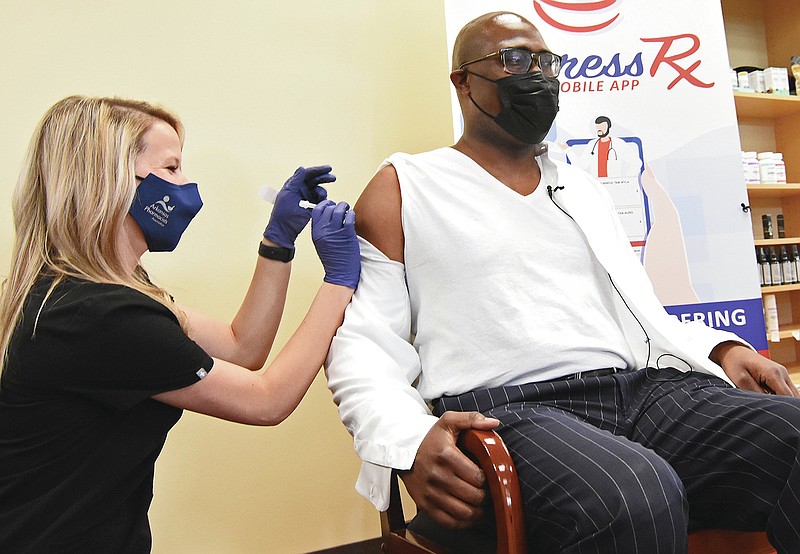 Whitney Campbell, a pharmacist for Express Rx, gives Mayor Frank Scott Jr. a dose of the Johnson & Johnson Covid-19 vaccine Wednesday, March 10, 2021 at the Express Rx at Otter Creek in Little Rock.
(Arkansas Democrat-Gazette/Staci Vandagriff)