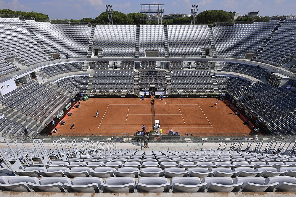 FILE - The stands around the Central Court of the Foro Italico are empty during a match between Serbia's Novak Djokovic and Italy's Salvatore Carus, at the Italian Open tennis tournament in Rome, in this Wednesday, Sept. 16, 2020, file photo. (Alfredo Falcone/LaPresse via AP)