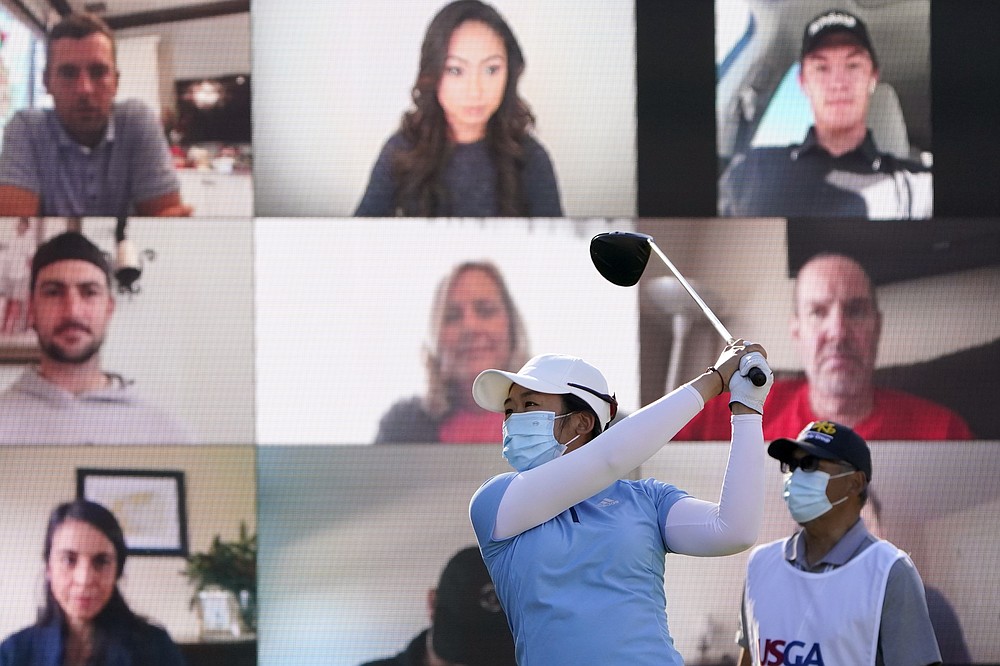 FILE - Jing Yan, of China, hits off the first tee as virtual fans, rear, look on during the first round of the U.S. Women's Open golf tournament in Houston, in this Thursday, Dec. 10, 2020, file photo. (AP Photo/Eric Gay, File)