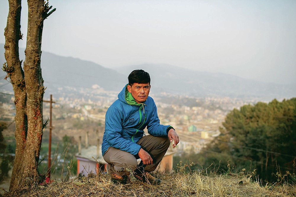 Pasang Rinzee Sherpa, 33, mountain guide poses for a photograph in Kathmandu, Nepal, Wednesday, March 3, 2021. Sherpa has scaled Mount Everest twice and spent 18 years helping climbers up the highest Himalayan peaks, generally earning about $8,000 a year. In the past 12 months, he had no income. (AP Photo/Niranjan Shrestha)