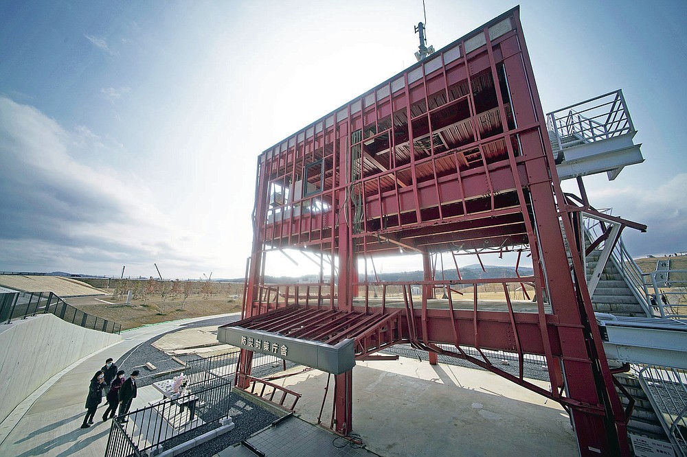 The skeleton of the tsunami-damaged disaster prevention headquarters where 43 workers died as the tsunami washed over it, is seen in Minamisanriku, Miyagi Prefecture, northern Japan, Saturday, March 6, 2021. The three-story building is one of legacies that still stand in northern Japan's coastal towns, 10 years after the earthquake and tsunami that killed more than 18,000 people. (AP Photo/Eugene Hoshiko)