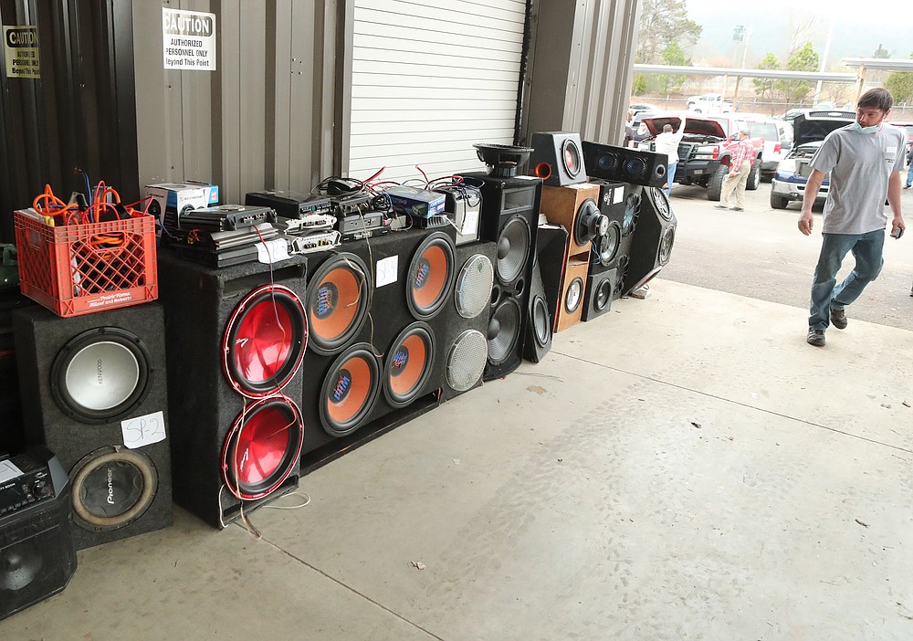 An unidentified man looks over some speakers at the 18th Judicial District East Drug Task Force auction at the Bill Edwards Center Friday. - Photo by Richard Rasmussen of The Sentinel-Record