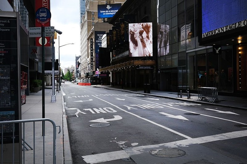 Broadway theaters stand closed along an empty street in the theater district on June 30 in New York. At the one-year anniversary of the fateful day, with the pandemic raging but in retreat, hopes for the industry’s return have crept up on the horizon. (Getty Images/TNS/Spencer Platt)