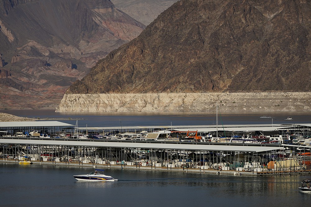 FILE - In this Aug. 13, 2020 file photo a bathtub ring of light minerals delineates the high water mark on Lake Mead at the Lake Mead National Recreation Area, near Boulder City, Nev. A plan by Utah could open the door to the state pursuing an expensive pipeline that critics say could further deplete the lake, which is a key indicator of the Colorado River's health. (AP Photo/John Locher, File)
