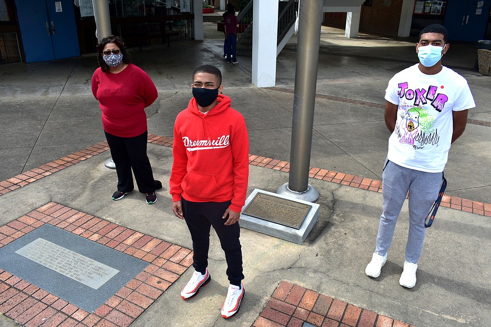 From left, Pine Bluff High School Principal Claudette White, 2021 senior Trenton Harris and 2020 graduate Joshua Hunt tackled challenges in the education landscape as a result of covid-19 during the past year. (Pine Bluff Commercial/I.C. Murrell)