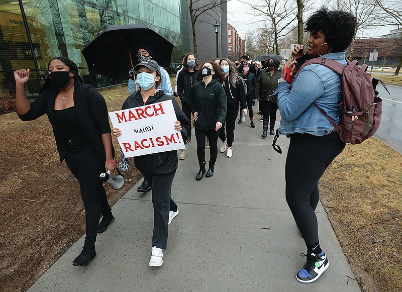 Tyrah Jackson (right), a student at the University of Arkansas from Pine Bluff, chants as she leads a large group of students and members of the campus community Saturday, March 13, 2021, on a march through campus during a rally in Fayetteville. Student organizations hosted the anti-racism rally to express support for the campus to disassociate from J. William Fulbright and Charles Brough, two historical figures who have been criticized for stances taken against civil rights and in support of white landowners after racial violence against Black citizens. Visit nwaonline.com/210314Daily/ for today's photo gallery. 
(NWA Democrat-Gazette/Andy Shupe)