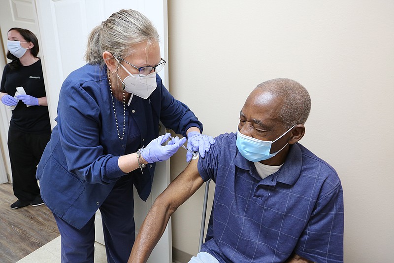 Nurse Lynn Carter gives Willie Hance his Covid-19 vaccine shot on Thursday, March 11, 2021, at Doctor's Orders Pharmacy in Pine Bluff. 
(Arkansas Democrat-Gazette/Thomas Metthe)