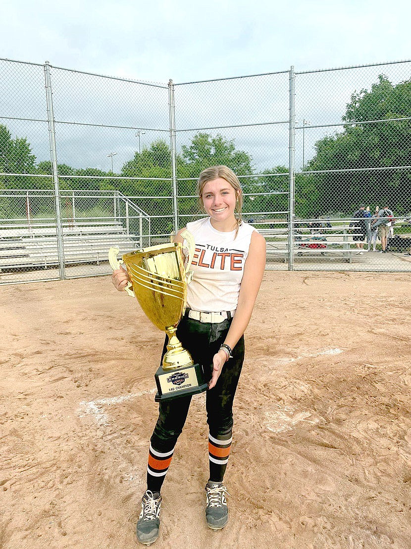 Submitted Photo/Lincoln rising ninth grader Brinkley Moreton holds the HFL summer championship softball trophy, which her travel ball team, the Tulsa Elite NWA06 24-25 won at Columbia, Mo. last weekend. Brinkley overcame a blood clot in her right arm, weeks of being on blood thinners administered through shots in the belly, and predictions she wouldn't play softball this summer, through dogged determination and faith combined with that of her parents and church family to experience a miracle that put her back on the playing field. Next her team goes to Nationals at Florida.
