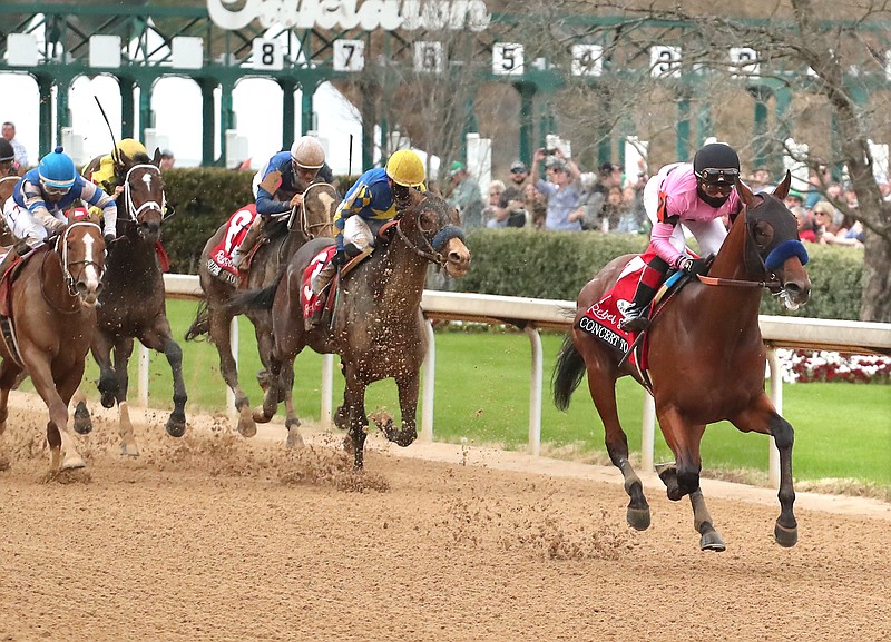 Jockey Joel Rosario, right, and Concert Tour (7) coast home to an easy victory in the Rebel Stakes at Oaklawn Racing Casino Resort Saturday, March 13. - Photo by Richard Rasmussen of The Sentinel-Record