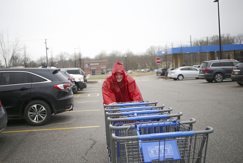 Walmart employee Jacob Morrison pushes carts, Friday, March 12, 2021 at a Walmart Neighborhood Market in Bentonville. Check out nwaonline.com/210313Daily/ for today's photo gallery. 
(NWA Democrat-Gazette/Charlie Kaijo)