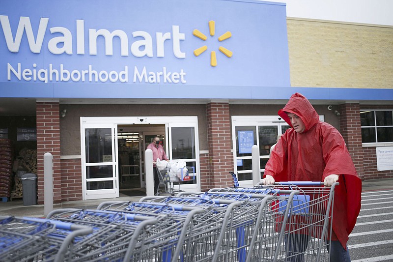Walmart employee Jacob Morrison pushes carts, Friday, March 12, 2021 at a Walmart Neighborhood Market in Bentonville. Check out nwaonline.com/210313Daily/ for today's photo gallery. 
(NWA Democrat-Gazette/Charlie Kaijo)