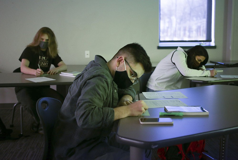 Students Calvin Burdess (from left), Lathan Snalley and Anna Barczewski participate in an exercise, Thursday, February 25, 2021 at Rogers New Tech High School in Rogers. Rogers Honors Academy students sat in on a college preparedness course. Check out nwaonline.com/210226Daily/ for today's photo gallery.
(NWA Democrat-Gazette/Charlie Kaijo)