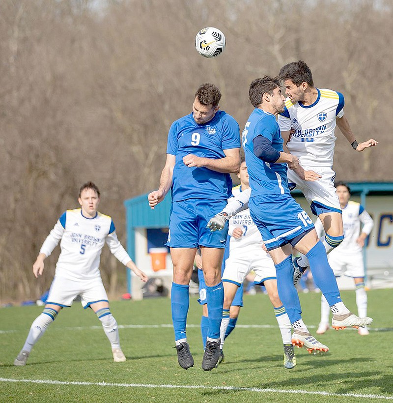 Photo courtesy of JBU Sports Information
John Brown's Oscar Carballo, right, goes high in the air to win a header Saturday against Oklahoma City at Alumni Field. JBU defeated Oklahoma City 3-1.