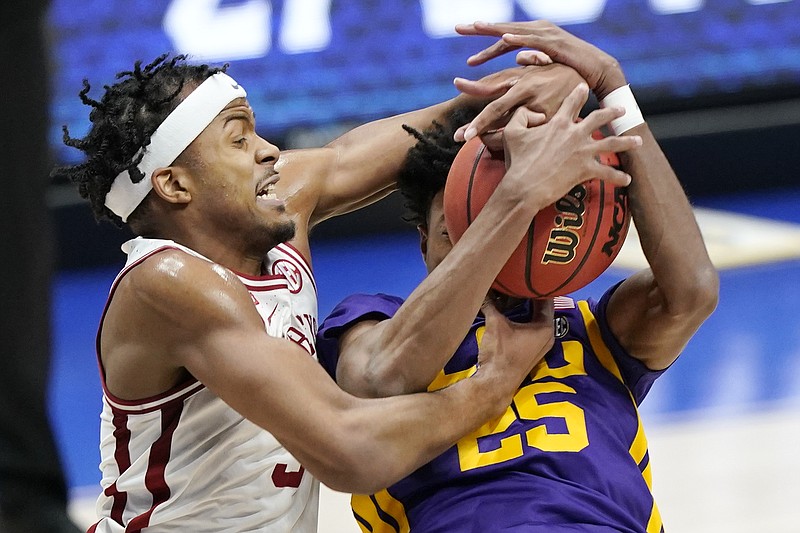 Arkansas' Moses Moody, left, and LSU's Eric Gaines (25) fight for a rebound in the first half of Saturday's Southeastern Conference Tournament semifinal in Nashville, Tenn. - Photo by Mark Humphrey of The Associated Press