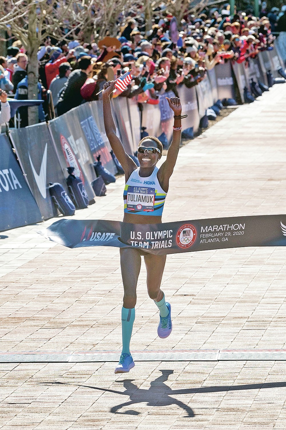 FILE - Aliphine Tuliamuk crosses the finish line to win the women's U.S. Olympic marathon trials, Saturday, Feb. 29, 2020, in Atlanta. When the Tokyo Summer Games were postponed, U.S. Olympic marathon trials champion Aliphine Tuliamuk decided with her fiance last year to have a baby instead of waiting. (AP Photo/John Amis, File)