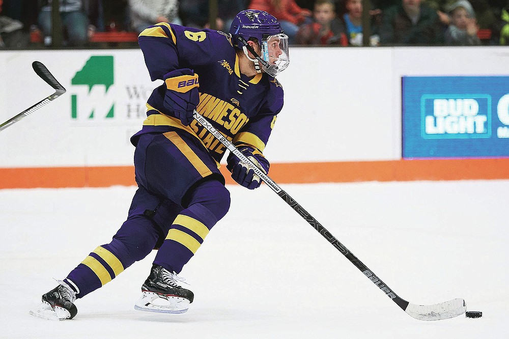 Minnesota State forward Parker Tuomie (6) skates with the puck against the Bowling Green during an NCAA college hockey game, Saturday, Dec. 15, 2018, in Bowling Green, Ohio. Parker Tuomie and the Minnesota State hockey team had their chase for the program’s first NCAA championship ended abruptly a year ago. Tuomie, a native of Germany, now plays professionally in Berlin. (AP Photo/Rick Osentoski, File)