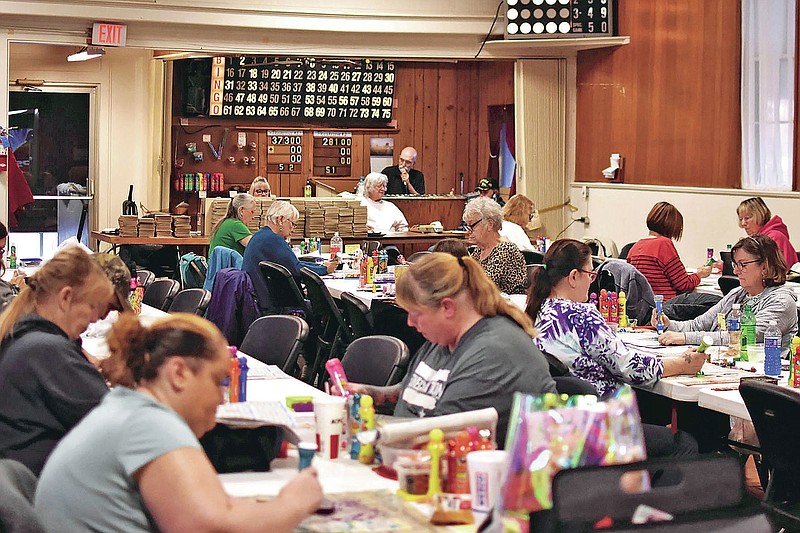 People play bingo at the Danish Brotherhood in Ludington, Mich., on March 4, 2021. Once upon a time, there was somewhere people could go to play bingo every night of the week in Mason County, but now, the Danish Hall in Ludington's Fourth Ward is the only one that remains. Every Thursday, the doors open at 4:30 p.m. and players get their bingo cards, set up their tables and get ready to win some money. (Hannah Hubbard/Ludington Daily News via AP)