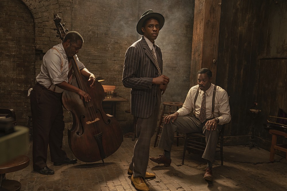 This image released by Netflix shows Michael Potts, from left, Chadwick Boseman and Colman Domingo in "Ma Rainey's Black Bottom." (David Lee/Netflix via AP)