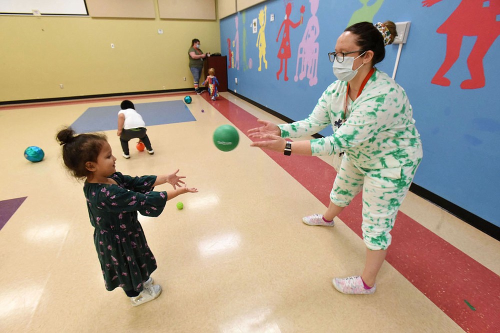 Teacher Katie Jennings plays with children on Wednesday March 17 2021 at the Benton County Sunshine School and Development Center.
(NWA Demorcrat-Gazette/Flip Putthoff)