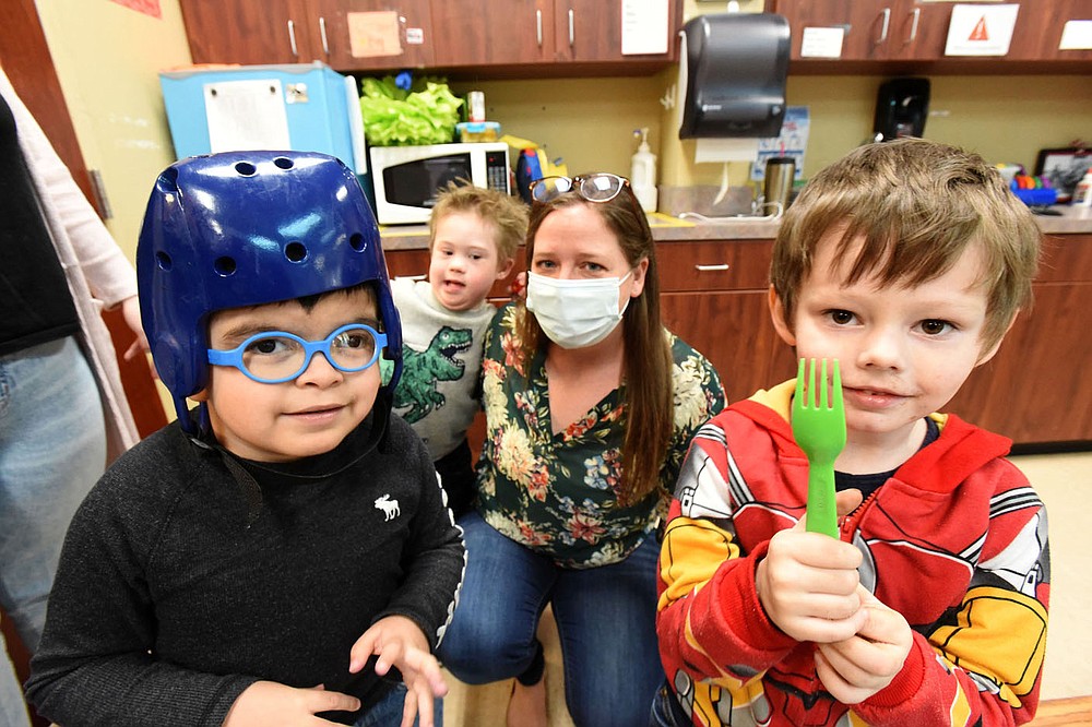 Sarah Pollack, in charge of philanthropy, plays with students on Wednesday March 17 2021 at the Benton County Sunshine School and Development Center in Rogers.
(NWA Democrat-Gazette/Flip Putthoff)