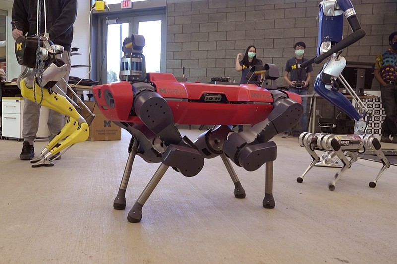 In a frame grab from video, robots walk across the floor of the University of Michigan's Ford Motor Co. Robotics Building, March 12, 2021 in Ann Arbor, Mich. The four-story, $75 million, 134,000-square-foot complex has three floors that house classrooms and research labs for robots that fly, walk, roll and augment the human body. (AP Photo/Carlos Osorio)