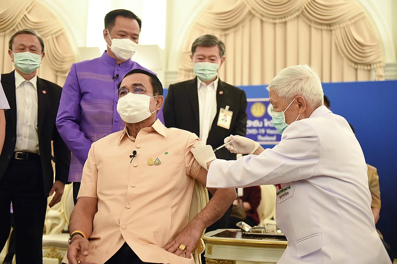 In this photo released by Government Spokesman Office, Thailand's Prime Minister Prayuth Chan-ocha, front left, receives a shot of the AstraZeneca's COVID-19 vaccine at government house in Bangkok, Thailand, Tuesday, March 16, 2021. (Government Spokesman Office via AP)