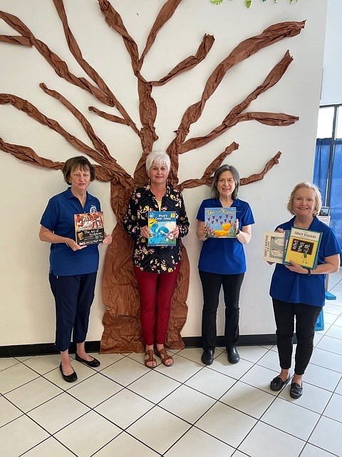 From left are Martha Smither, Mary Smith, Melanie Pederson, and Sue Spurgin, with some of the books. - Submitted photo
