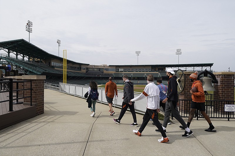 The Texas basketball team walks around the concourse Wednesday at Victory Field at the NCAA basketball tournament in Indianapolis. - Photo by Darron Cummings of The Associated Press