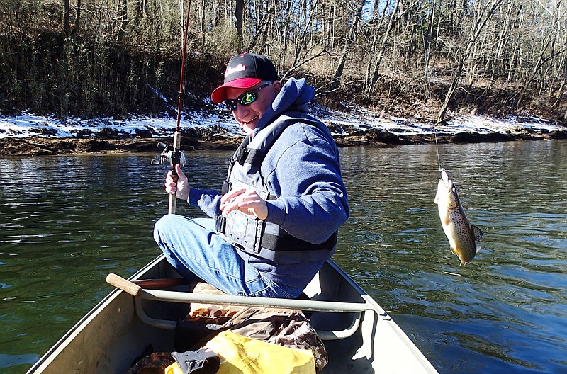 With snow still on the ground, Keith Brashers catches a rainbow trout Feb. 23 2021 during a float trip on the White River below Beaver Dam. Launching at the dam and floating to Houseman Access makes a fine 7-mile canoe trip.
(NWA Democrat-Gazette/Flip Putthoff)