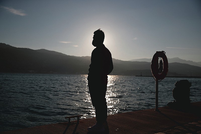 An Afghan father stands at the port of Vathy on the eastern Aegean island of Samos, Greece, Monday, Feb. 22, 2021. On a hill above a small island village, the sparkling blue of the Aegean just visible through the pine trees, lies a boy’s grave. His first ever boat ride was to be his last - the sea claimed him before his sixth birthday. His 25-year-old father, like so many before him, had hoped for a better life in Europe, far from the violence of his native Afghanistan. But his dreams were dashed on the rocks of Samos, a picturesque Greek island almost touching the Turkish coast. Still devastated from losing his only child, the father has now found himself charged with a felony count of child endangerment. (AP Photo/Thanassis Stavrakis)