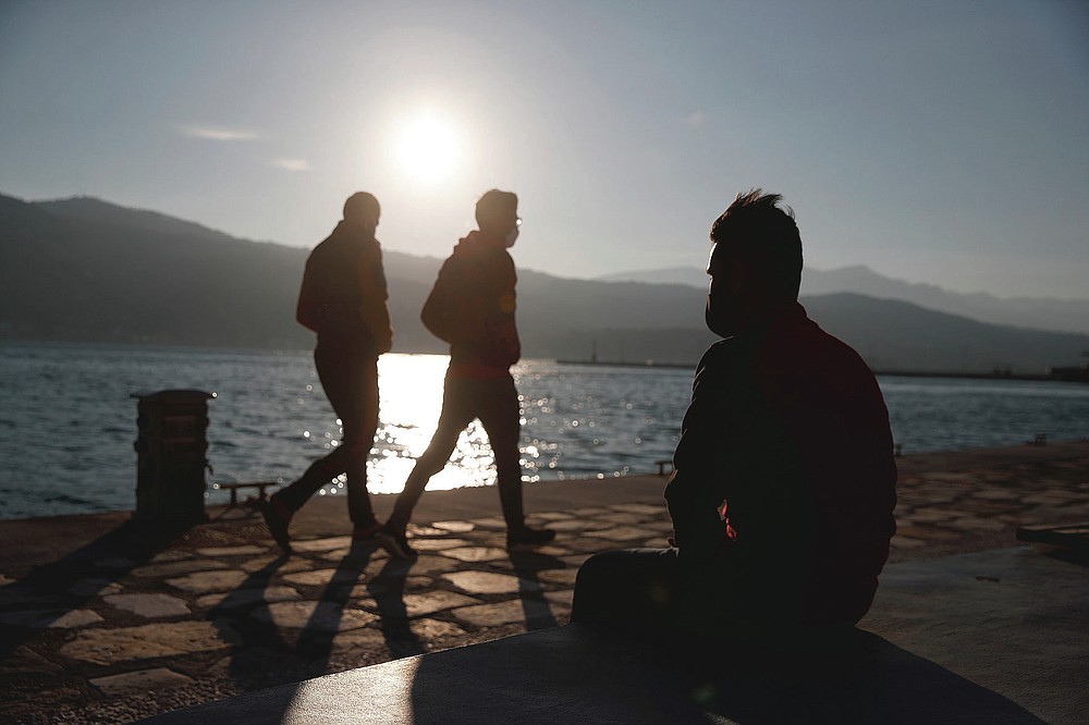 An Afghan father sits on a bench at the port of Vathy on the eastern Aegean island of Samos, Greece, Monday, Feb. 22, 2021. On a hill above a small island village, the sparkling blue of the Aegean just visible through the pine trees, lies a boy’s grave. His first ever boat ride was to be his last - the sea claimed him before his sixth birthday. His 25-year-old father, like so many before him, had hoped for a better life in Europe, far from the violence of his native Afghanistan. But his dreams were dashed on the rocks of Samos, a picturesque Greek island almost touching the Turkish coast. Still devastated from losing his only child, the father has now found himself charged with a felony count of child endangerment. (AP Photo/Thanassis Stavrakis)