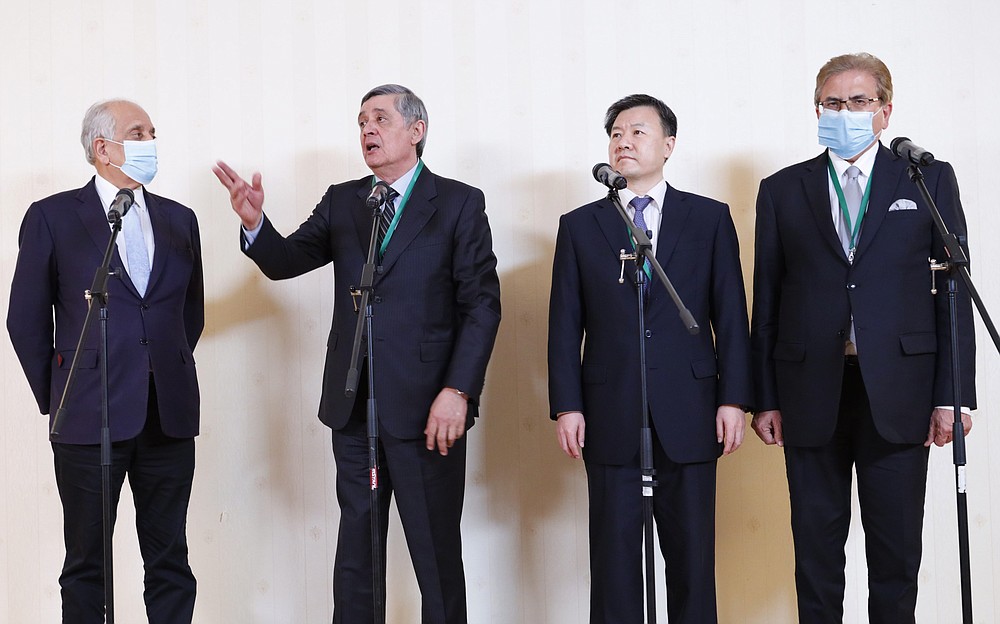 CORRECTING NAME OF AMBASSADOR TO WANG YU - Special Representative of the President of the Russian Federation on Afghanistan Zamir Kabulov, second left, speaks to media as Special Representative of the US Department of State on Afghanistan reconciliation, SRAR, Zalmay Khalilzad, left, Ambassador of China to Afghanistan Wang Yu, second right, and Special Representative of Pakistan on Afghanistan Mohammad Sadiq, right, look on after an international peace conference in Moscow, Russia, Thursday, March 18, 2021. The one-day gathering Thursday is the first of three planned international conferences ahead of a May 1 deadline for the final withdrawal of U.S. and NATO troops from the country, a date fixed under a year-old agreement between the Trump administration and the Taliban. (AP Photo/Alexander Zemlianichenko, Pool)