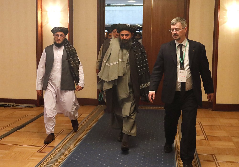 Taliban co-founder Mullah Abdul Ghani Baradar, centre, arrives with other members of the Taliban delegation for attending an international peace conference in Moscow, Russia, Thursday, March 18, 2021.Russia is hosting a peace conference for Afghanistan, bringing together government representatives and their Taliban adversaries along with regional observers in a bid to help jump-start the country's stalled peace process. The one-day gathering Thursday is the first of three planned international conferences ahead of a May 1 deadline for the final withdrawal of U.S. and NATO troops from the country, a date fixed under a year-old agreement between the Trump administration and the Taliban. (AP Photo/Alexander Zemlianichenko, Pool)