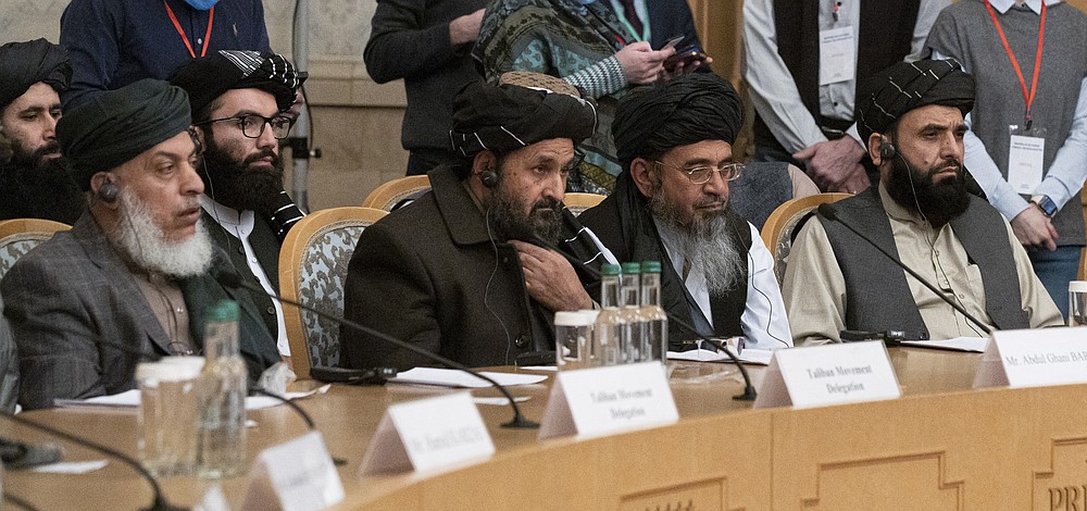 Taliban co-founder Mullah Abdul Ghani Baradar, center, with other members of the Taliban delegation attend an international peace conference in Moscow, Russia, Thursday, March 18, 2021. Russia is hosting a peace conference for Afghanistan, bringing together government representatives and their Taliban adversaries along with regional observers in a bid to help jump-start the country's stalled peace process. The one-day gathering Thursday is the first of three planned international conferences ahead of a May 1 deadline for the final withdrawal of U.S. and NATO troops from the country, a date fixed under a year-old agreement between the Trump administration and the Taliban. (AP Photo/Alexander Zemlianichenko, Pool)