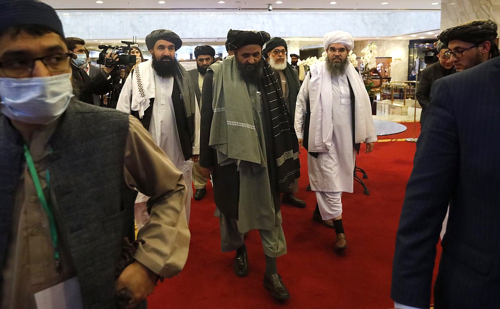 Taliban co-founder Mullah Abdul Ghani Baradar, centre, arrives with other members of the Taliban delegation for attending an international peace conference in Moscow, Russia, Thursday, March 18, 2021. Russia is hosting a peace conference for Afghanistan, bringing together government representatives and their Taliban adversaries along with regional observers in a bid to help jump-start the country's stalled peace process. The one-day gathering Thursday is the first of three planned international conferences ahead of a May 1 deadline for the final withdrawal of U.S. and NATO troops from the country, a date fixed under a year-old agreement between the Trump administration and the Taliban.. (AP Photo/Alexander Zemlianichenko, Pool)