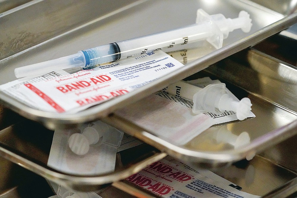 FILE - In this Thursday, March 18, 2021 file photo, syringes are filled with the Moderna COVID-19 vaccine at a pop up site in New York. On Friday, March 18, 2021, The Associated Press reported on stories circulating online incorrectly asserting that COVID-19 vaccines contain aluminum, a toxic ingredient that enters the brain and causes disease. The COVID-19 vaccines that have been authorized for emergency use in the United States do not contain any aluminum, according to their ingredient lists. Nor do the AstraZeneca or Sputnik V vaccines. Some Chinese COVID-19 vaccines, as well as some vaccines used against other diseases, do use tiny amounts of aluminum to help boost the immune response. This method is safe and the quantity of aluminum is trivial compared to what humans encounter elsewhere in everyday life, experts say. Aluminum has been used in vaccines since the 1930s as an adjuvant, or immune booster, according to the Centers for Disease Control and Prevention. (AP Photo/Mary Altaffer)