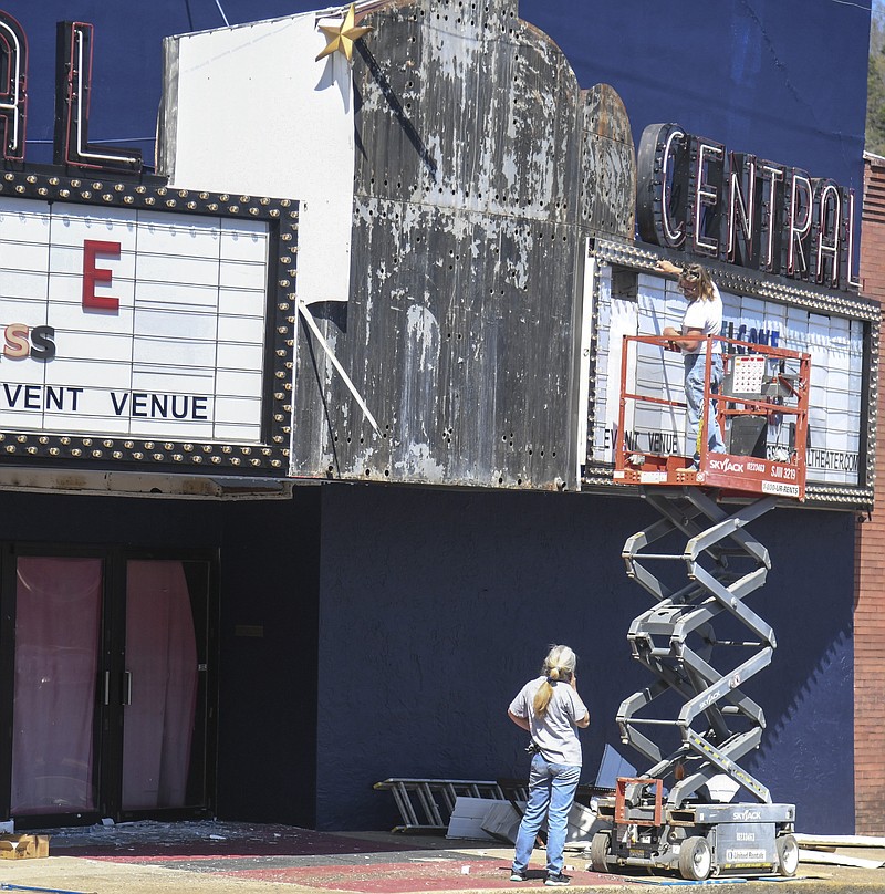 A small crew works on the marquee for the Central Theater on Sunday. Local Realtor Chris Rix purchased the property and is currently renovating it. - Photo by Grace Brown of The Sentinel-Record