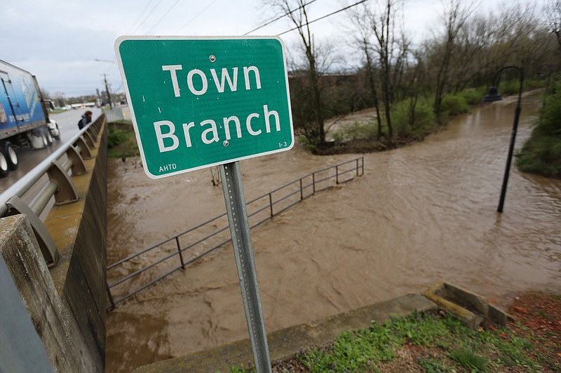 Water floods out of Town Branch Creek Thursday, March 19, 2020, and covers a section of the Razorback Greenway near South School Avenue in Fayetteville. Heavy rains caused flooding and submerged portions of the Razorback Regional Greenway Trail including portions of the Town Branch section. Check out nwaonline.com/200320Daily/ and nwadg.com/photos for a photo gallery.
(NWA Democrat-Gazette/David Gottschalk)