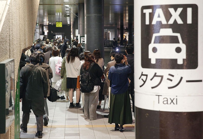 People queue up for taxi as train services are suspended following an earthquake in Sendai, Miyagi prefecture, Japan Saturday, March 20, 2021. A strong earthquake struck Saturday off northern Japan, shaking buildings even in Tokyo and triggering a tsunami advisory for a part of the northern coast. (Kyodo News via AP)