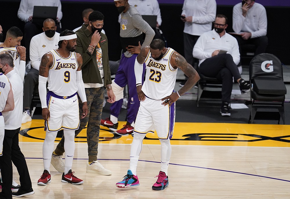 Los Angeles Lakers forward LeBron James (23) tries to shake off an injury during the first half of an NBA basketball game against the Atlanta Hawks Saturday, March 20, 2021, in Los Angeles. (AP Photo/Marcio Jose Sanchez)