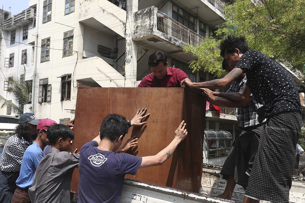 State railway employees load furniture in to a truck after being evicted from their home Saturday, March 20, 2021, in Mandalay, Myanmar. State railway workers in Mandalay have been threatened with eviction to force them to end their support for the Civil Disobedience Movement (CDM) against military rule. (AP Photo)