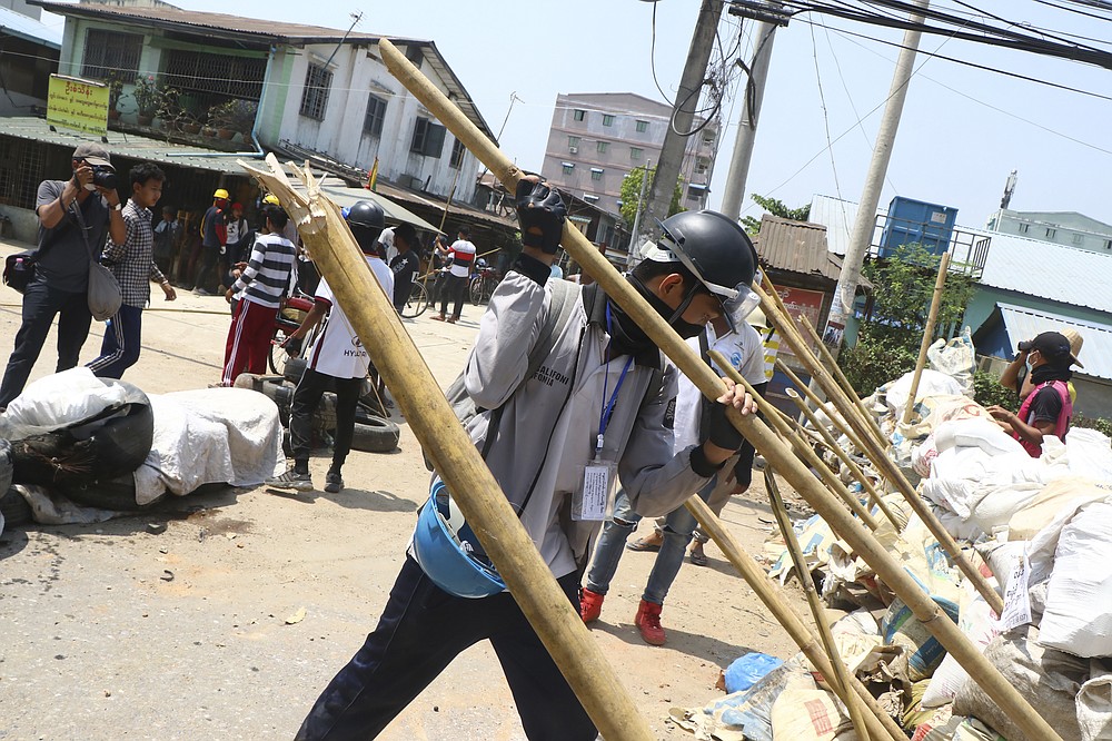 Protesters prepare to defend themselves as they gather in Tarkata township, Yangon, Myanmar Saturday, March 20, 20201. Protests against last month's military takeover continued Saturday in cities and town across Myanmar despite a crackdown by security forces that has taken more than 200 lives. (AP Photo)