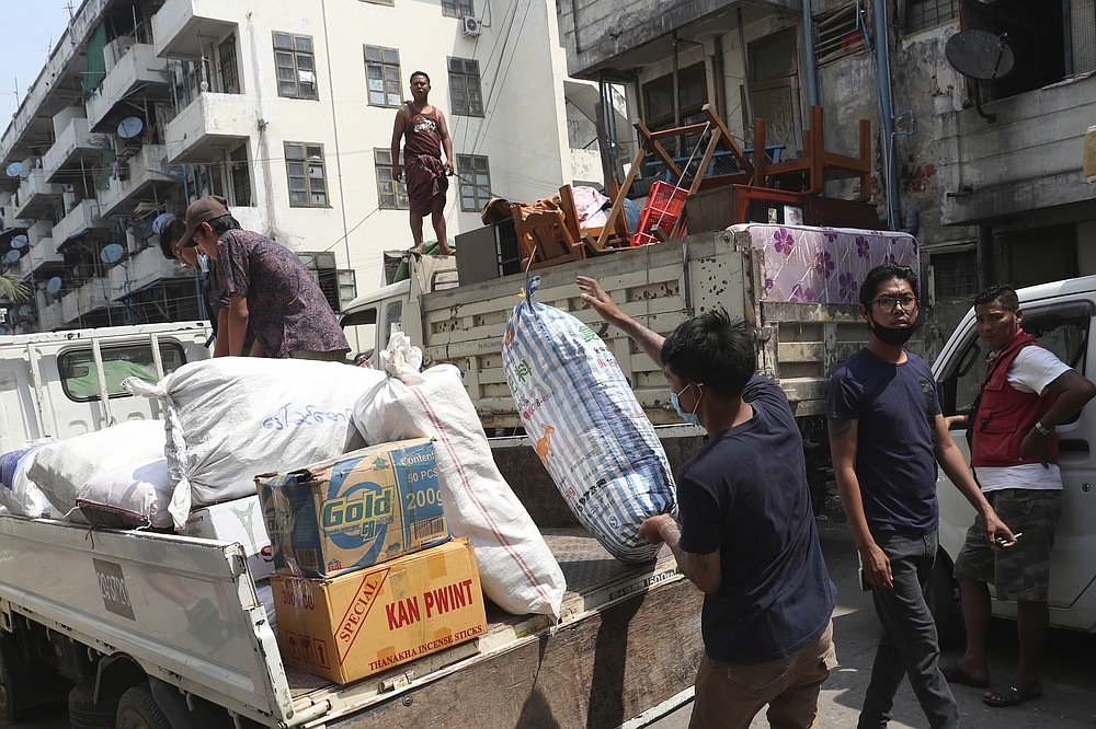 State railway employee load belongings after being evicted from their homes Saturday, March 20, 2021, in Mandalay, Myanmar. State railway workers in Mandalay have been threatened with eviction to force them to end their support for the Civil Disobedience Movement (CDM) against military rule. (AP Photo)