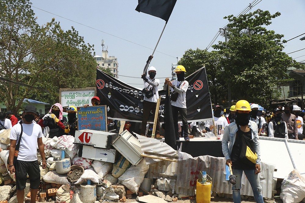 Protesters prepare to defend themselves as they gather in Tarkata township, Yangon, Myanmar Saturday, March 20, 20201. Protests against last month's military takeover continued Saturday in cities and town across Myanmar despite a crackdown by security forces that has taken more than 200 lives. (AP Photo)