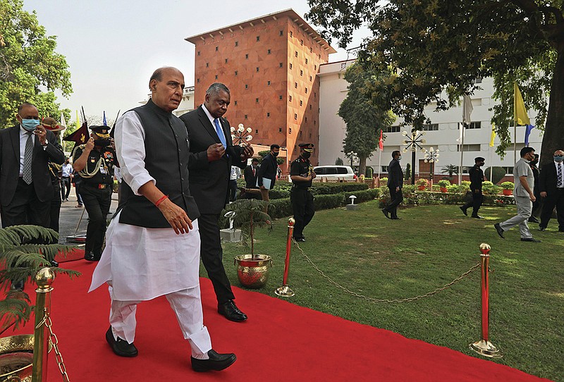 Indian Defense Minister Rajnath Singh (foreground, left) and U.S. Defense Secretary Lloyd Austin walk to a meeting Saturday in New Delhi. The officials said the two countries will expand their military engagement.
(AP/Manish Swarup)