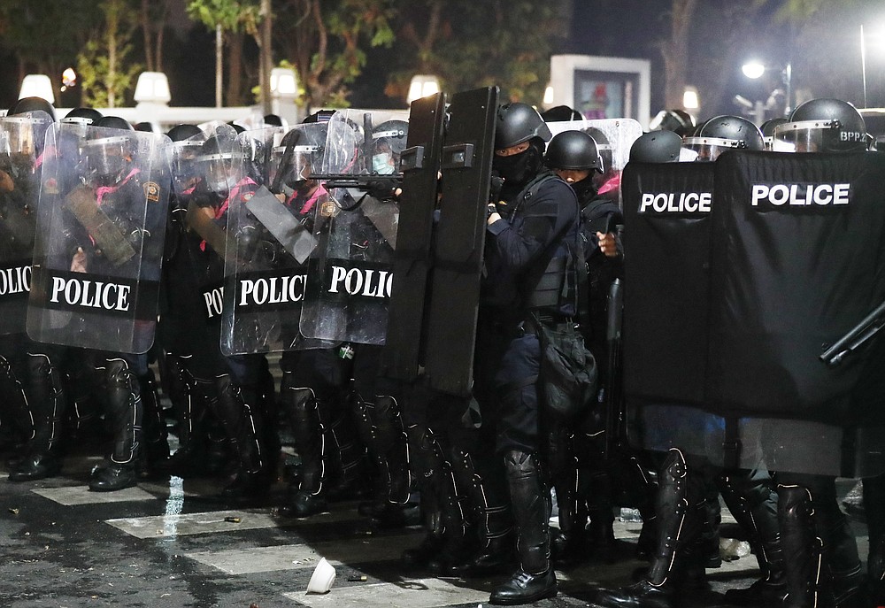 Riot police stand in formation preparing to disperse protesters who removed container vans used as a barricade in front of the Grand Palace Saturday, Mar. 20, 2021 in Bangkok, Thailand. Thailand's student-led pro-democracy movement is holding a rally in the Thai capital, seeking to press demands that include freedom for their leaders, who are being held without bail on charges of defaming the monarchy. (AP Photo/Sakchai Lalit)