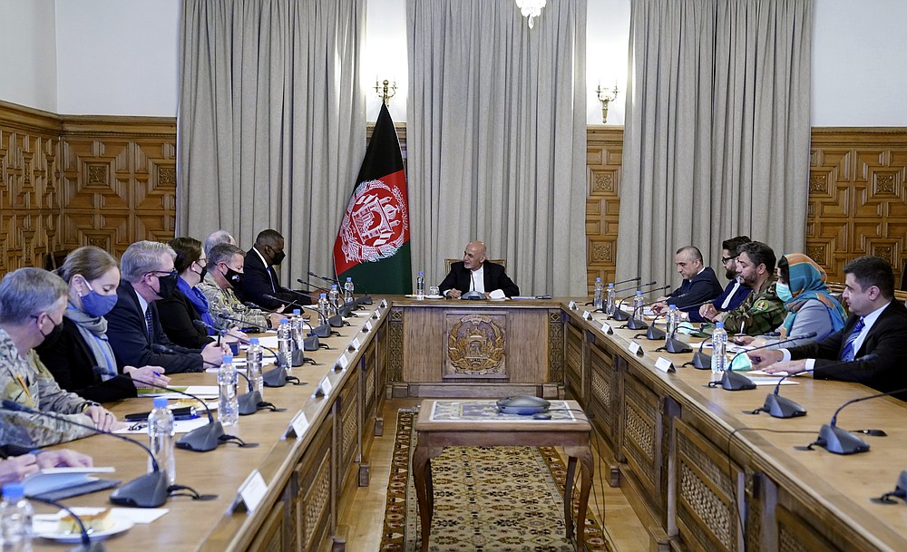 Afgan President Ashraf Ghani, center, meets with U.S. Defense Secretary Lloyd Austin, center left, and their delegations, at the presidential palace in Kabul, Afghanistan, Sunday, March 21, 2021. Austin arrived in Kabul on his first trip to Afghanistan as Pentagon chief, amid swirling questions about how long American troops will remain in the country. (Presidential Palace via AP)