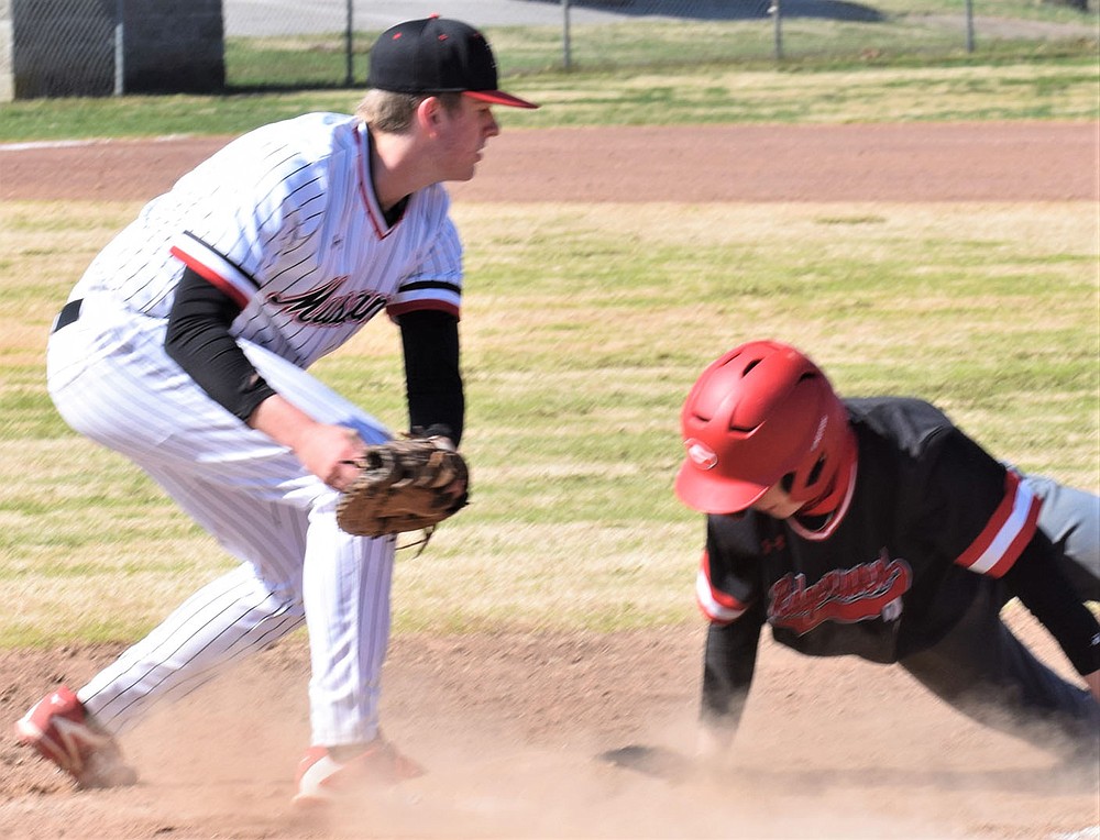 RICK PECK/SPECIAL TO MCDONALD COUNTY PRESS McDonald County first baseman Weston Gordon looks too late to tag out a Grove runner on a pick-off attempt during the Mustangs' 6-4 win in the consolation finals of the Ozarks Baseball Classic on March 20 in Harrison, Ark.