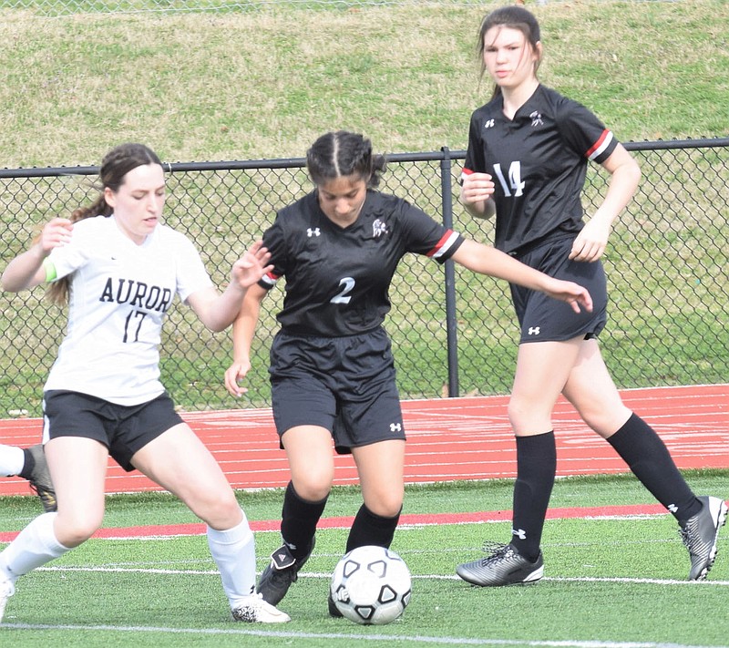 RICK PECK/SPECIAL TO MCDONALD COUNTY PRESS McDonald County's Yarecci Quintero dribbles away from an Aurora defender during a jamboree held on March 16 at McDonald County High School.